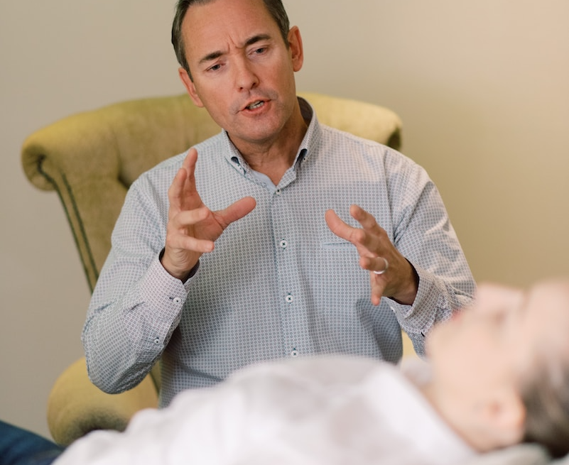 man in blue dress shirt sitting on yellow chair